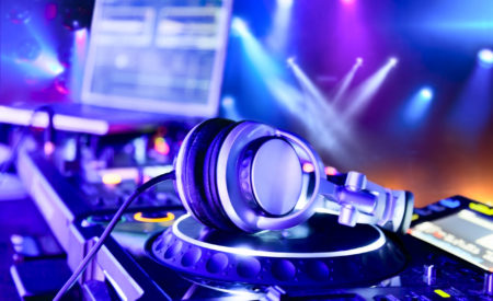 Dj mixer with headphones at nightclub