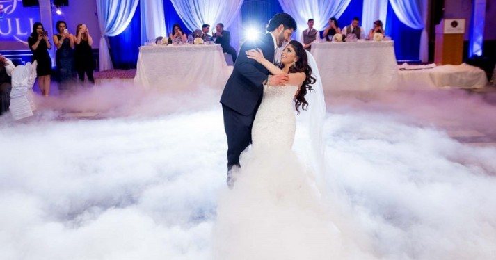 Couple dancing on low-lying fog clouds