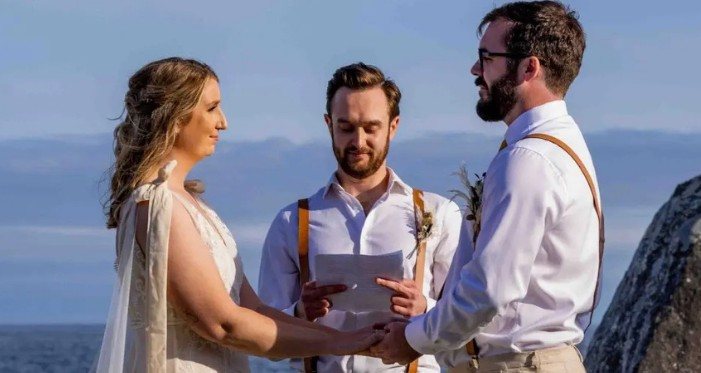 Licensed officiant leading a seaside wedding ceremony